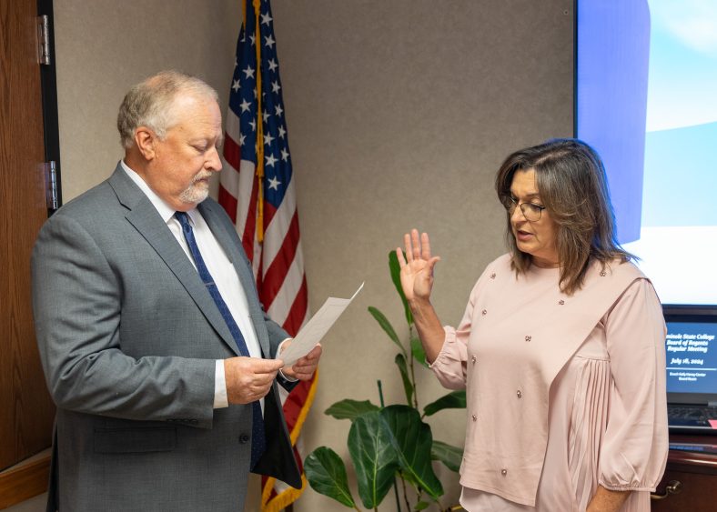 In this photo Newly appointed Regent Teresa Burnett (right) is sworn in for a seven-year term on the SSC Board of Regents by her husband, Brad Burnett (left), at the meeting on July 18.