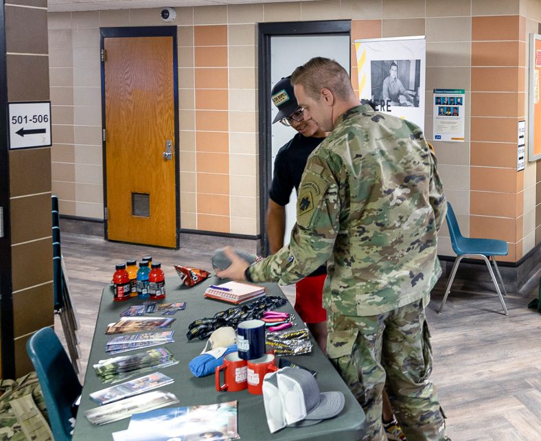 In this photo, an Army National Guard recruiter speaks with an SSC student during a career and transfer fair held on the Seminole State College campus.