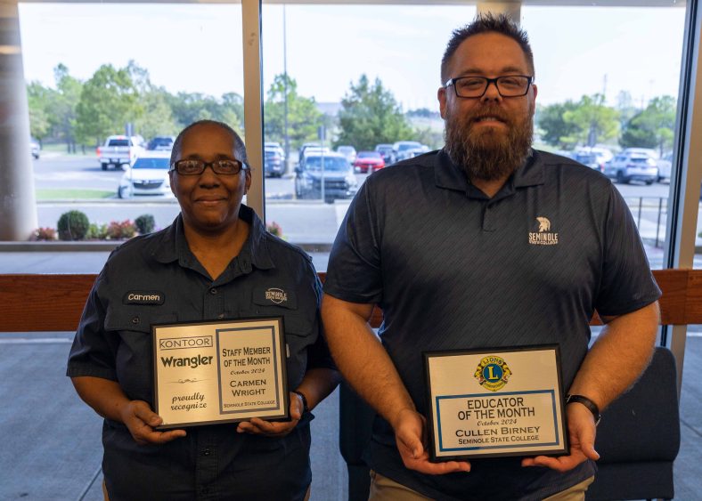 Pictured posing with their awards are Custodian Carmen Wright (left) the Staff Member of the Month and Assistant Professor of Math Cullen Birney (right) the Faculty Member of the Month at their Forum on Oct. 10