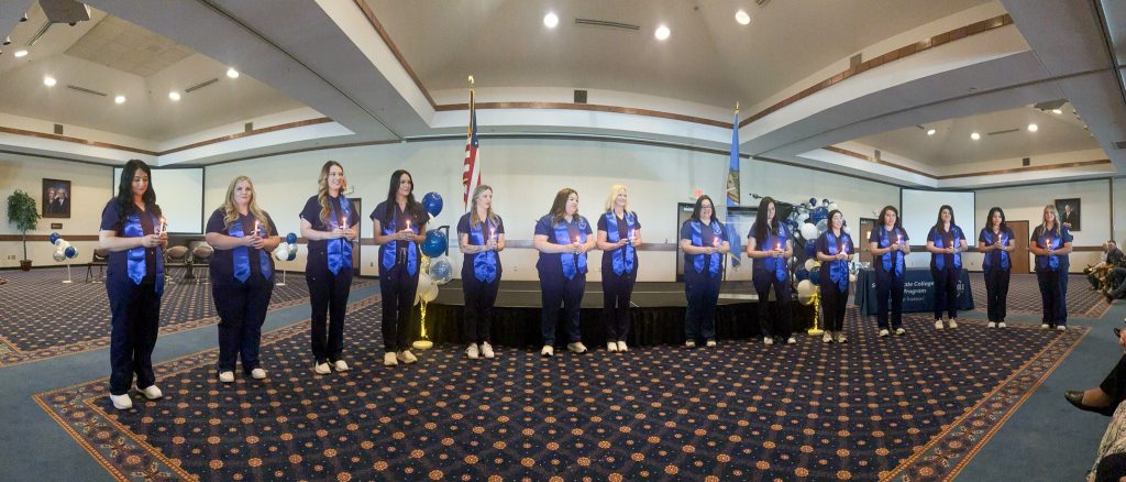 Pictured are SSC nursing graduates as they take part in the candle lighting portion of their pinning ceremony, signifying the transition from student to one of service.