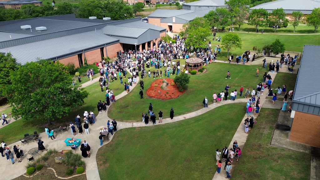 An ariel view shows recent graduates and their family and friends as they fill the courtyard on SSC's campus.