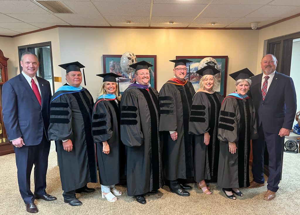 Pictured (left to right): Speaker McCall, Regents, Regents Curtis Morgan, Robyn Ready, Ryan Pitts, Chair Kim Hyden, Marci Donaho and Rep. Wallace pose for a group photo before SSC’s commencement ceremony.