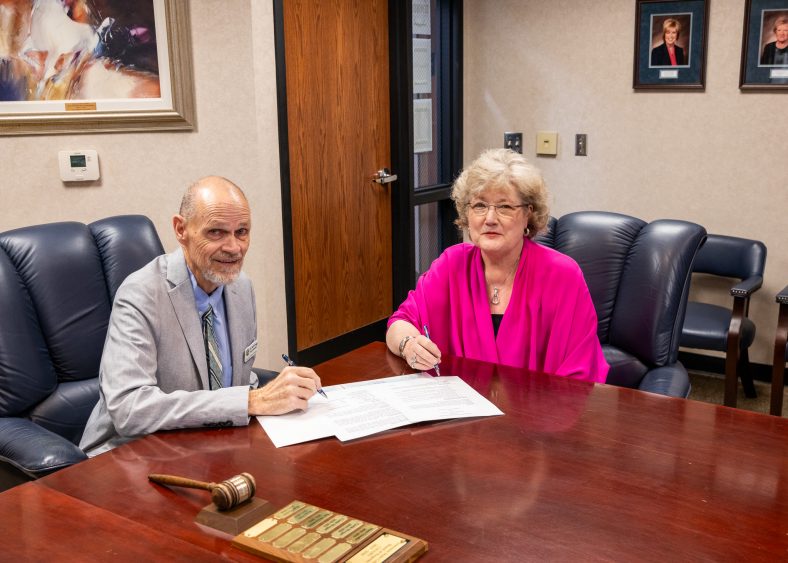 Pictured are Seminole Public Schools Superintendent Dr. Bob Gragg (left) and Seminole State College President Lana Reynolds (right) signing a partnership for the development of an agriculture education farm at the site of Pleasant Grove School.