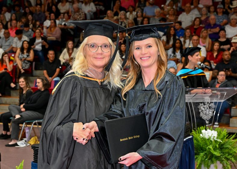 Pictured is Jessica Downey (right) as she receives her diploma from her mother, Mechell Downey (left) at the Seminole State College commencement ceremony on May 3. Downey completed her Pre-Engineering associate degree.