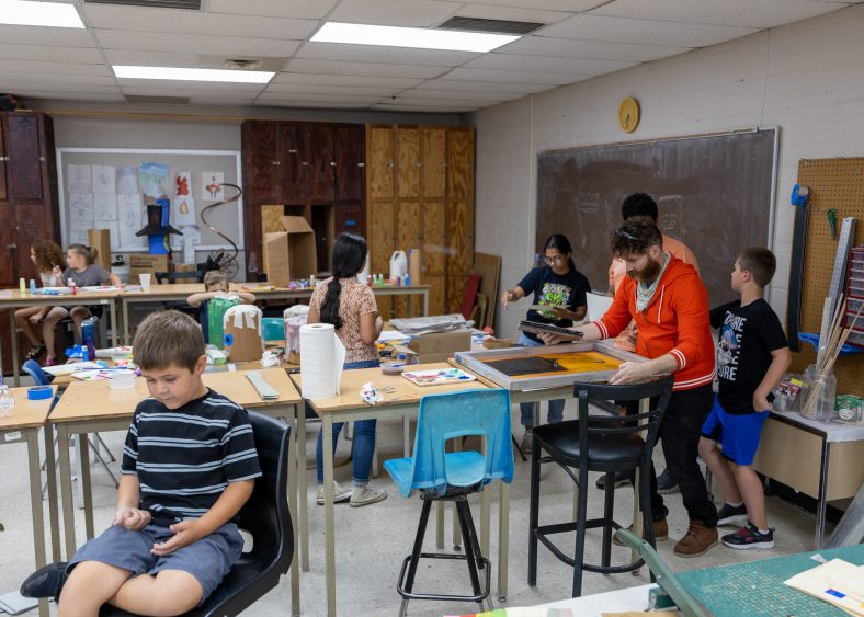 In this photo, children are shown participating in the 2023 Summer Art Camp.
