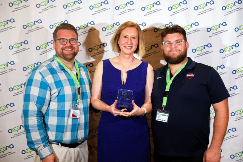 In this photo, pictured left to right, Director of Communications Josh Hutton, Director of Community Relations Kim Pringle and Web and Multimedia Coordinator Brooks Nickell pose for a photo with the two awards they received at the 2024 Oklahoma College Public Relations Association annual conference in Tulsa.