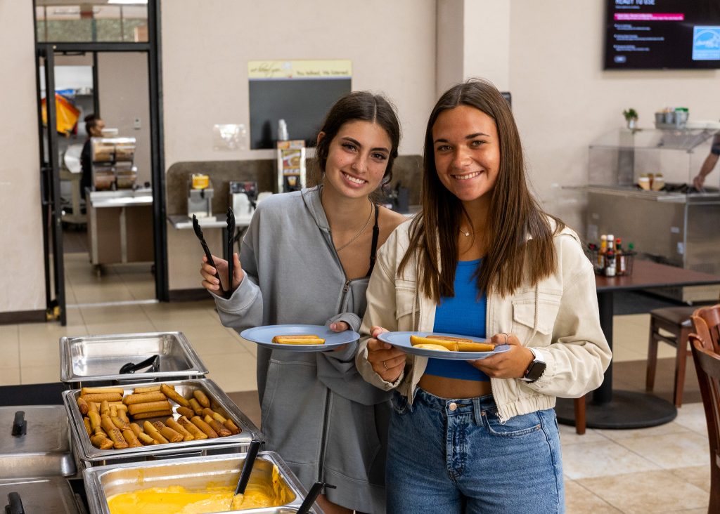 In this photo, Freshman Kara Doan of Little Elm, Texas (left), and sophomore McKenna Ingram of Bristow enjoy the pretzel bar provided by SSC Student Activities.