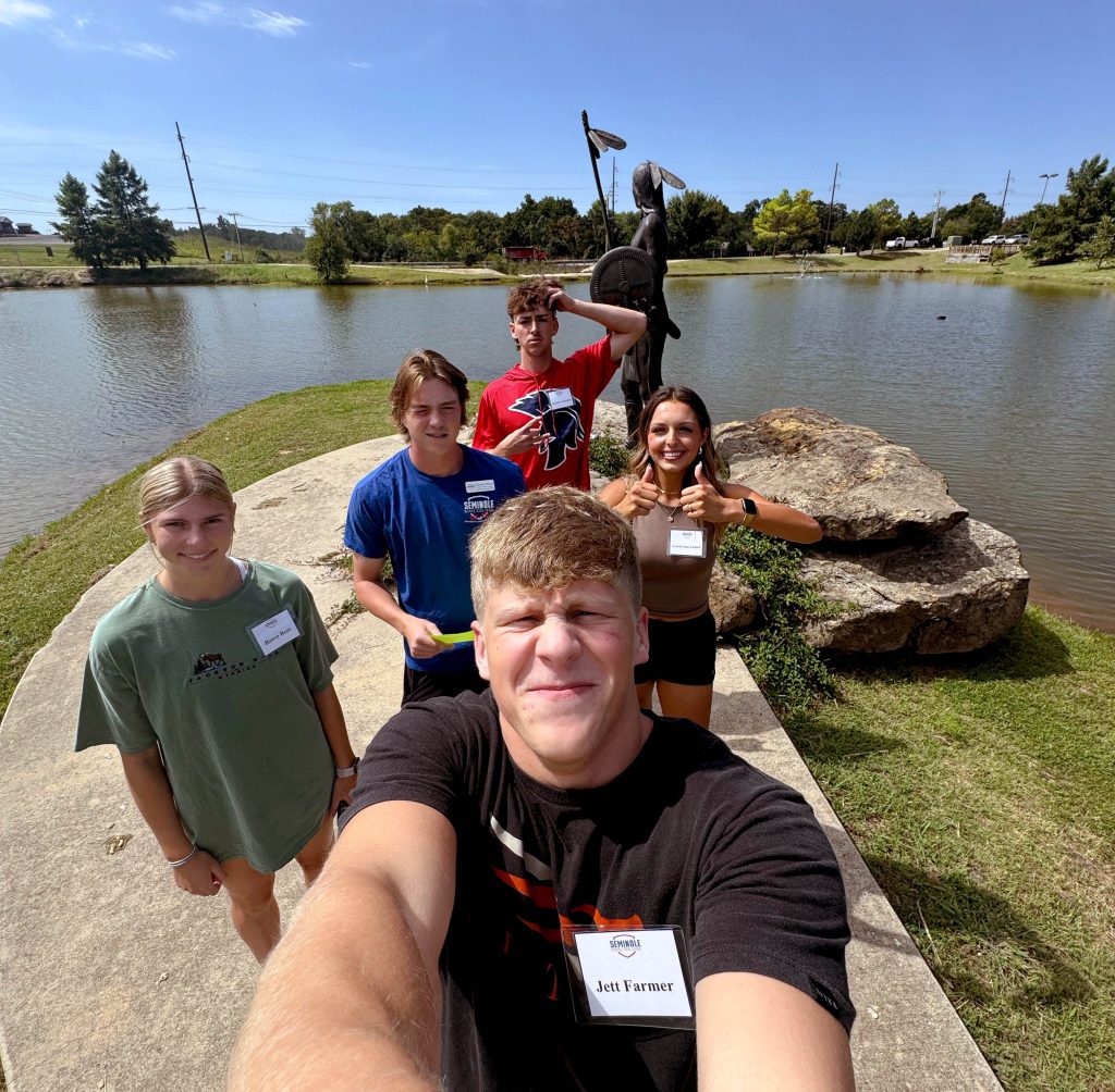 PLC students pose in front of a statue created by Kelly Haney. Pictured (left to right): Reeve Ross of Locust Grove, Clayton Moore of Norman, Jett Farmer (front) of Choctaw, Brayden Harpole (back) of Burkburnett, Texas, and Gracie-Jane Lasiter of Eufaula.