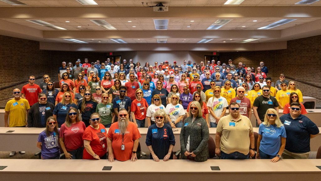 In this photo, Seminole State College faculty and staff pose for a group photo wearing sunglass. 