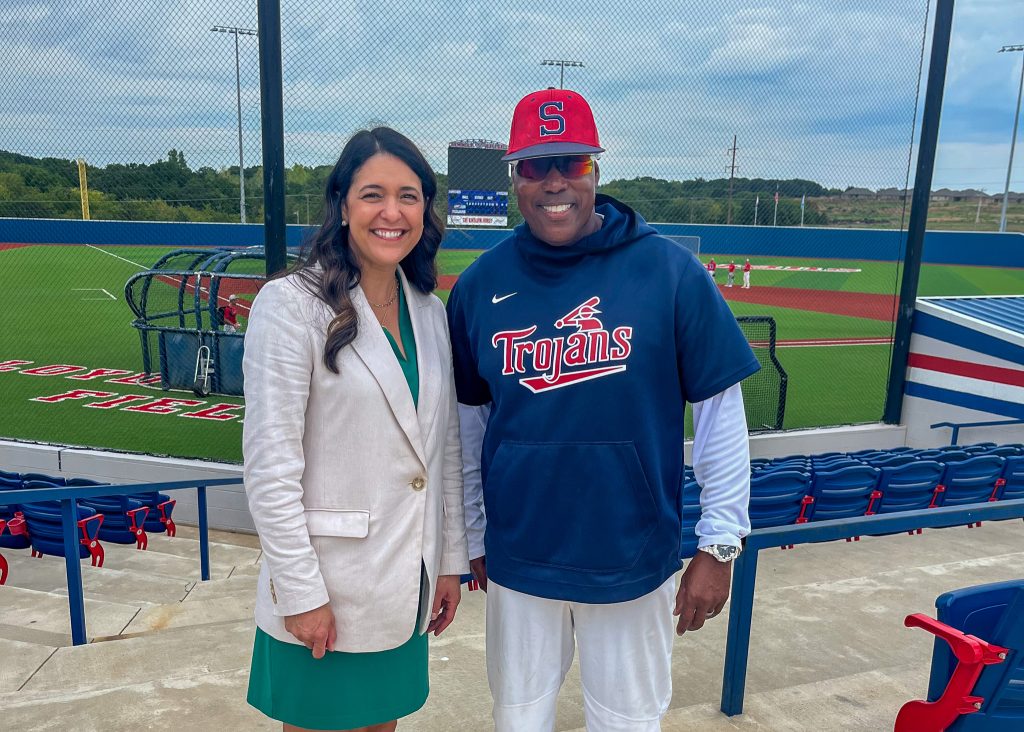 In this photo, Congresswoman Bice (left) and SSC Baseball Head Coach Mack Chambers (right) pose for a photo in front of Lloyd Simmons Field.