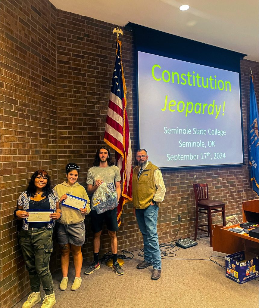 In this photo, Christiansen (far right) presented the top three winners with prizes following the Jeopardy competition. Pictured (left to right): Rae Factor of Wewoka, Angelina Sims of Shawnee and Troy Edwards of Davenport.