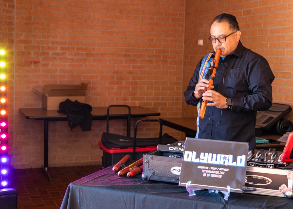 In this photo, Native American flutist and DJ Oliver Pruitt, who performs under the moniker Olywurld, performs for attendees before the start of the symposium.