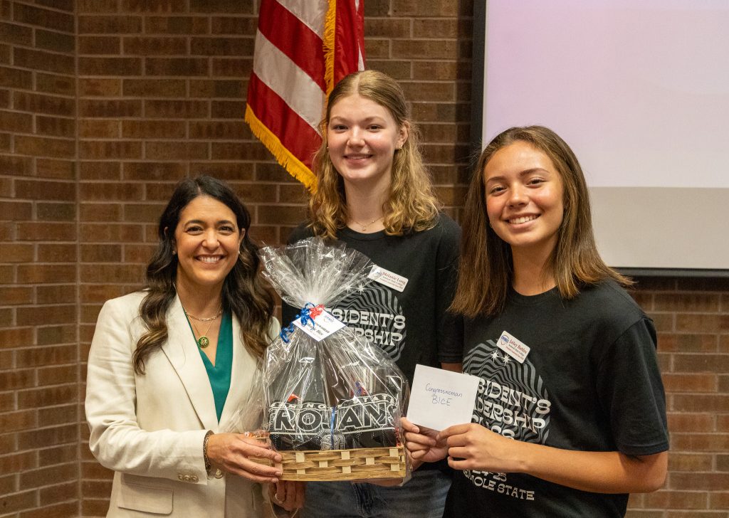 In this photo, PLC students Melanie Long of Mustang (center) and Jailey Battles of Sapulpa (right) present Congresswoman Bice with a Oklahoma-shaped gift basket of SSC items to thank her for visiting campus.