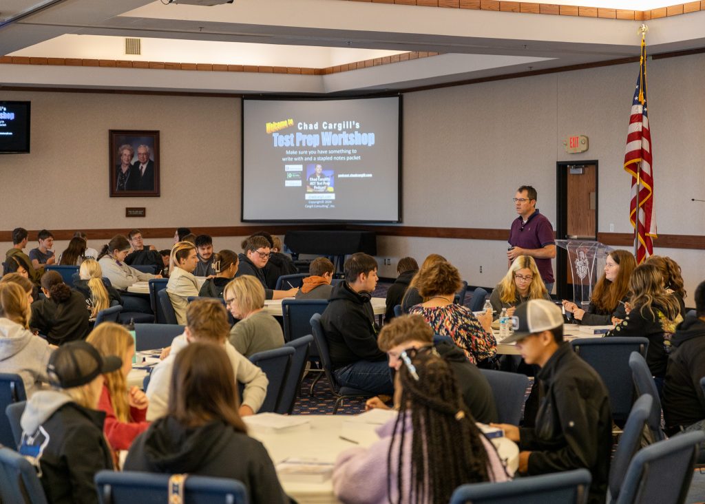 In this photo, Chad Cargill speaks to area high school students about strategies for taking the ACT.