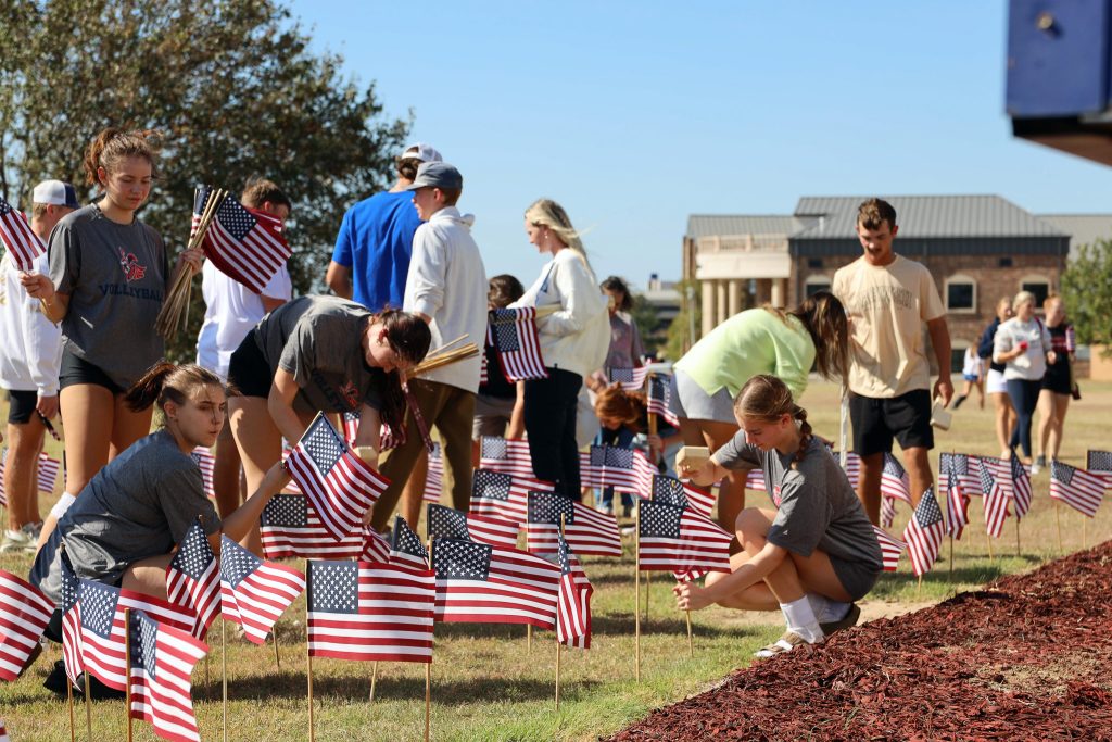 In this photo, SSC students are shown planting American flags on campus for an honor field at the intersection of Highways 9 and 3.