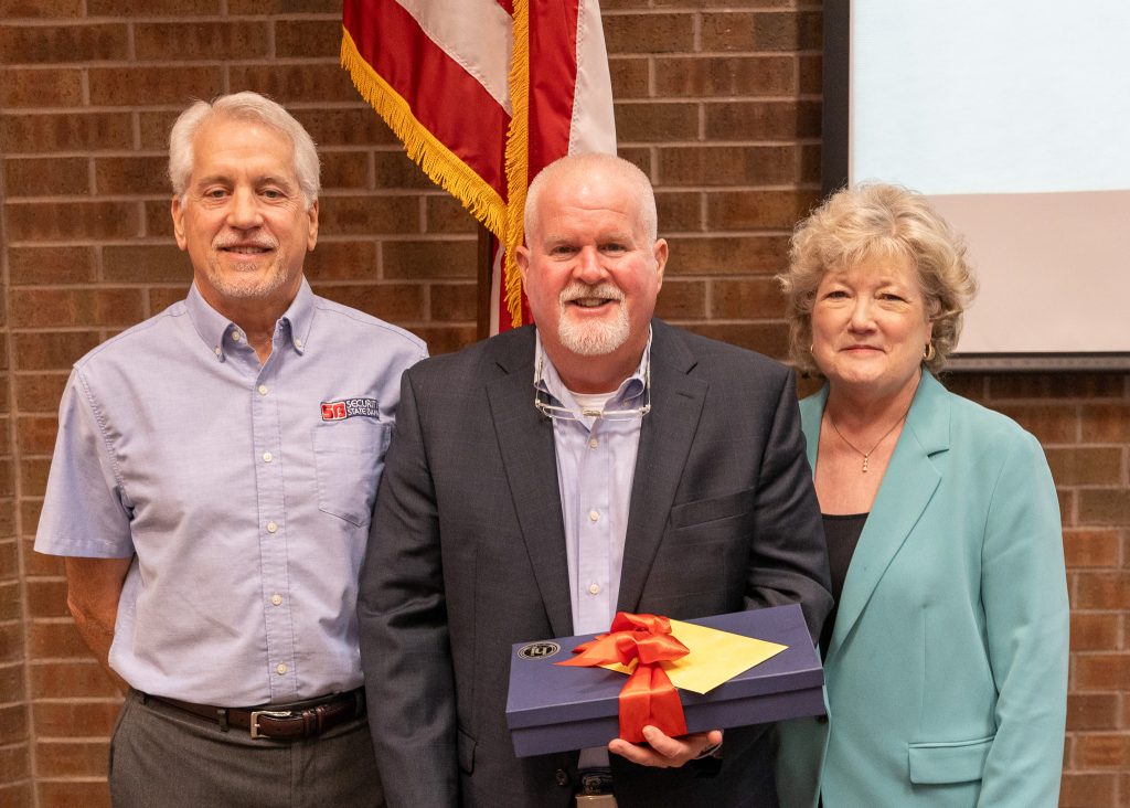 In this photo, Incoming SSC Educational Foundation Chair Mark Schell (left) and SSC President Lana Reynolds (right) thank outgoing Chair Lance Wortham for his service.