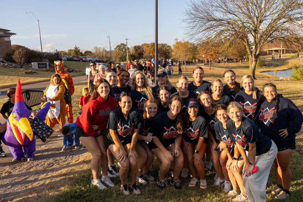 In this photo, SSC softball team members pose for a group photo. They were one of several campus groups that passed out candy along the Henderson Park walking trail.