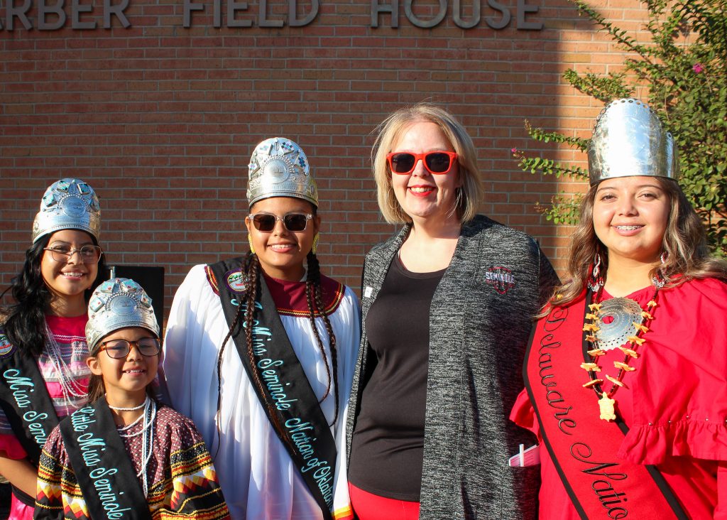 In this photo, Pictured (left to right): Little Miss Seminole Nation Emma Wise, Junior Miss Seminole Nation Analees Martinez, Miss Seminole Nation Adyson Beaver, SSC Vice President for Finance, Grants and Enrollment Melanie Rinehart and Delaware Nation Princess Kayleigh Combs pose for a group photo.