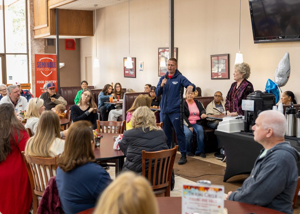 In this photo, Head Coach Dan Hill speaks to the crowd in attendance.