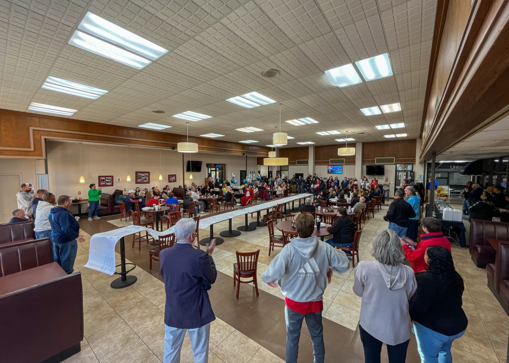 In this photo, a large crowd is gathered inside the SSC student union to wish the Trojan soccer team good luck as they head off to the NJCAA National Tournament,