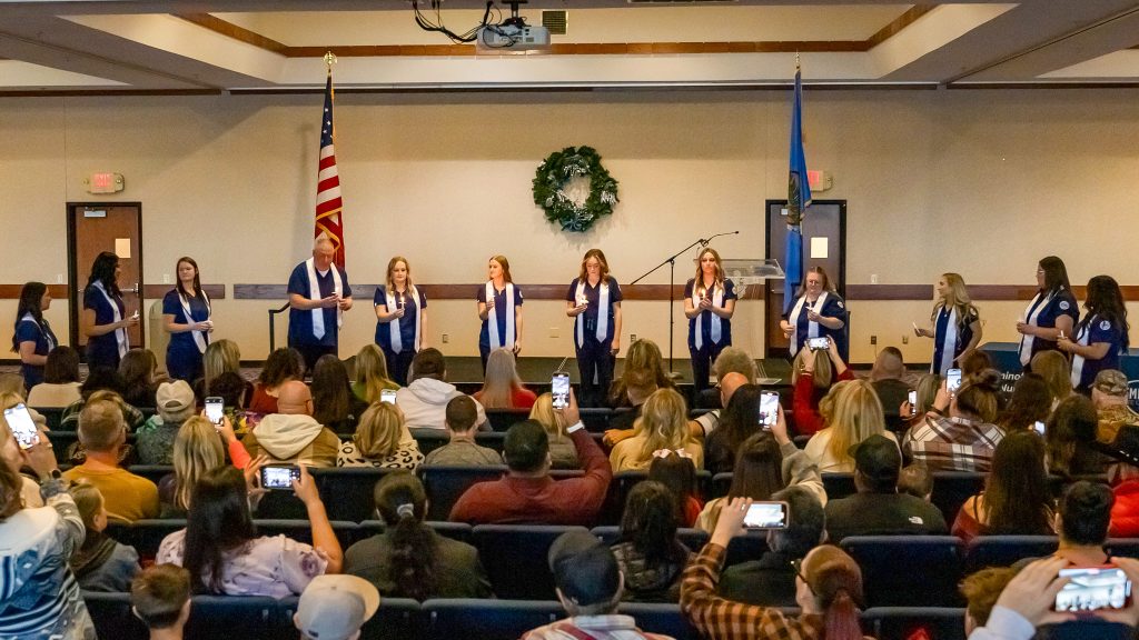 In this photo, nursing students expected to meet degree requirements this semester participate in a candle lighting ceremony signifying the transition from student to one of service.