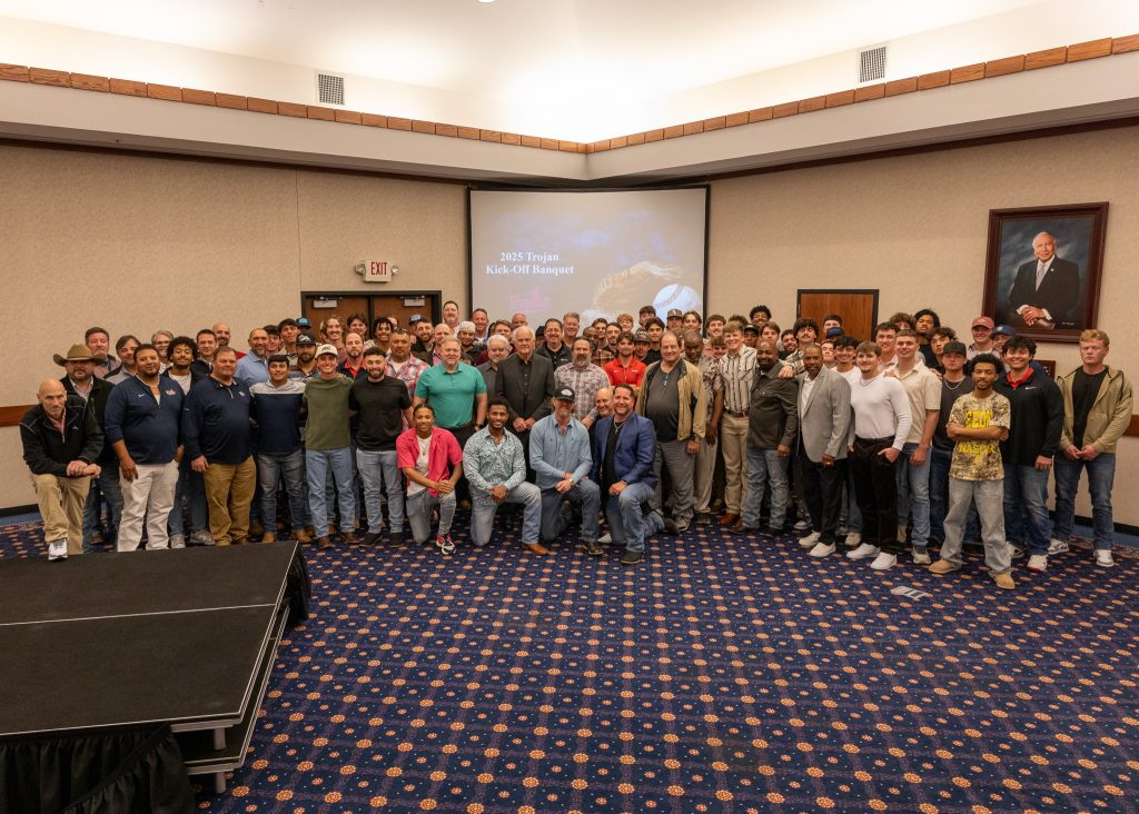 In this photo, Current and past Trojan players and coaches pose for a group picture following the banquet.