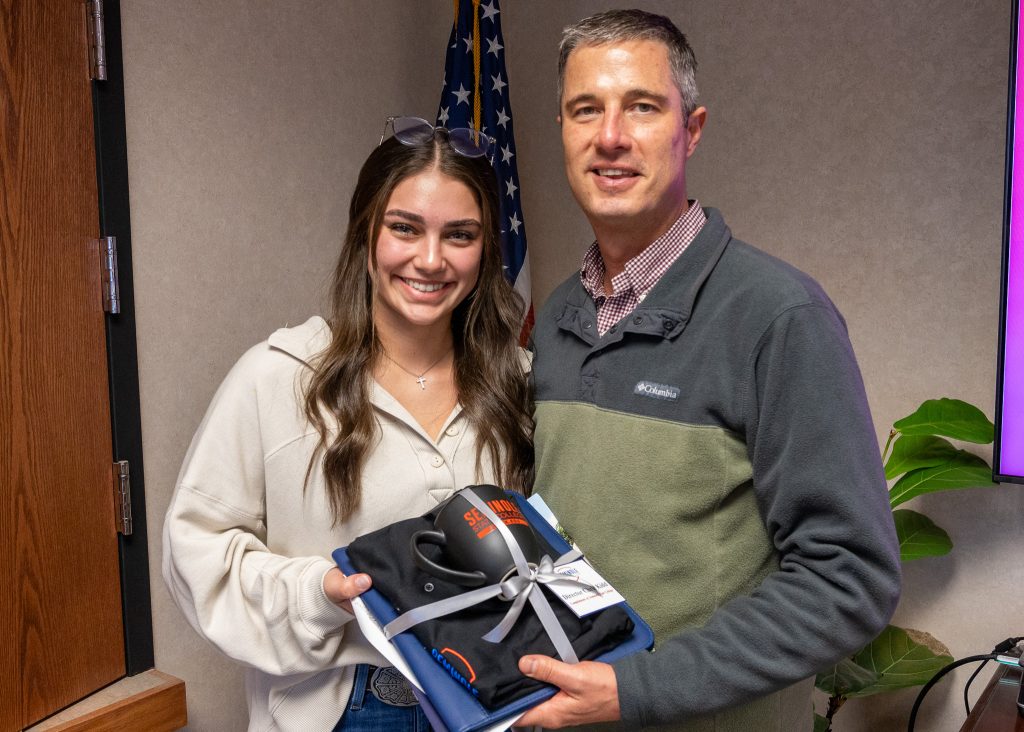 In this photo, SSC Student Government President Adisen Williamsen (left), freshman from Mustang, presented Kidd (right) with a gift from the college.