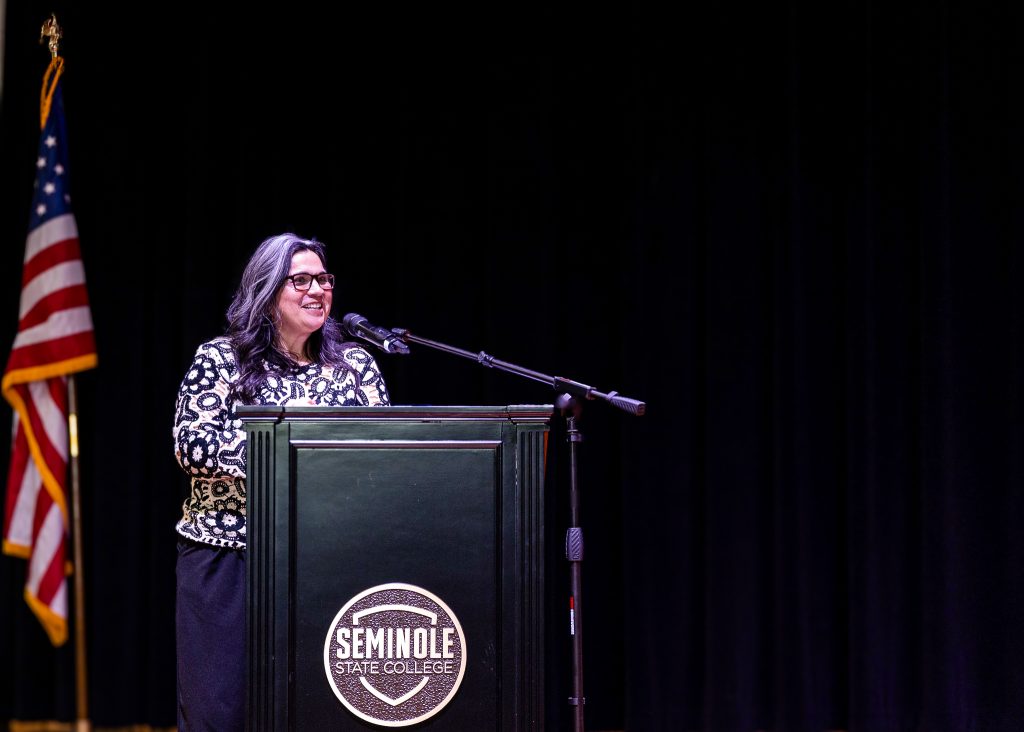 In this photo, Seminole State College’s Physical Therapist Assistant program Director Shakira Stafford speaks at last spring’s pinning ceremony for graduates of the program from the ceremony stage.