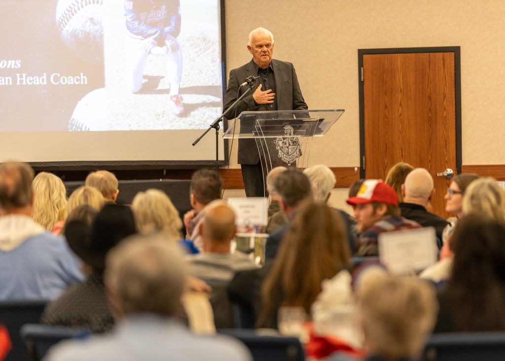 In this photo, former Seminole State College Head Baseball Coach Lloyd Simmons speaks to the crowd during the 2024 Trojan Baseball First Pitch Banquet.