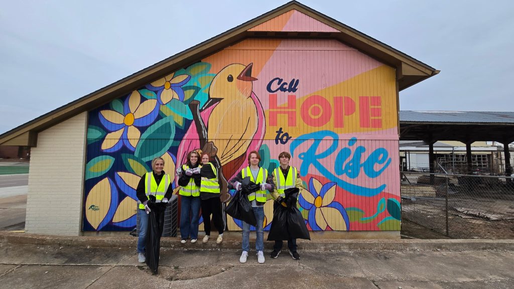 In this photo, pictured left to right, Upward Bound Coordinator Anna Skender, Upward Bound students Sosie Tucker, Marissa Massey, Jace Fitzgerald and Noah Higgins pose for a photo during their time spent helping clean up the community.